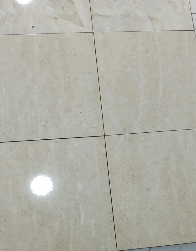 Glossy beige travertine-effect tiles